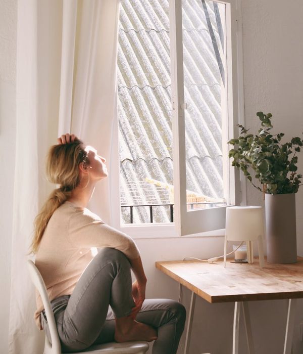 Person meditating peacefully in a brightly lit room.
