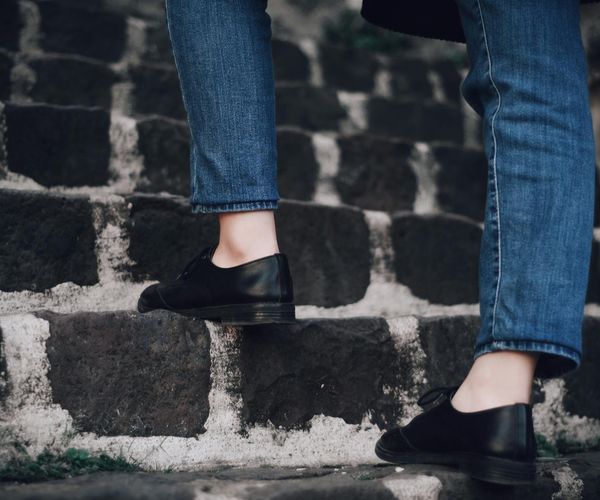 Person's feet in comfortable shoes on a path, ready to walk.